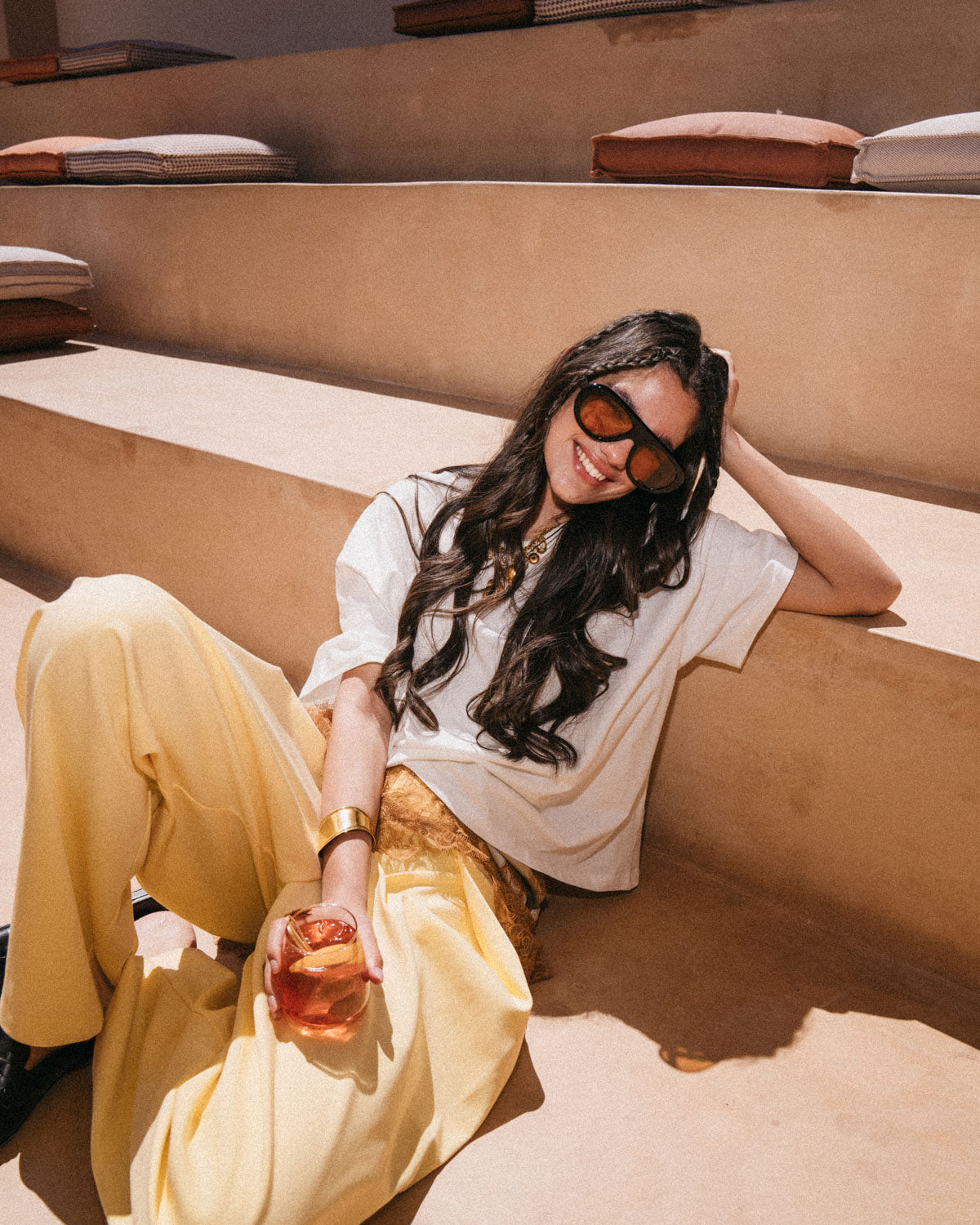 Woman wearing ME & JOE Riviera black sunglasses with orange lenses –lifestyle view