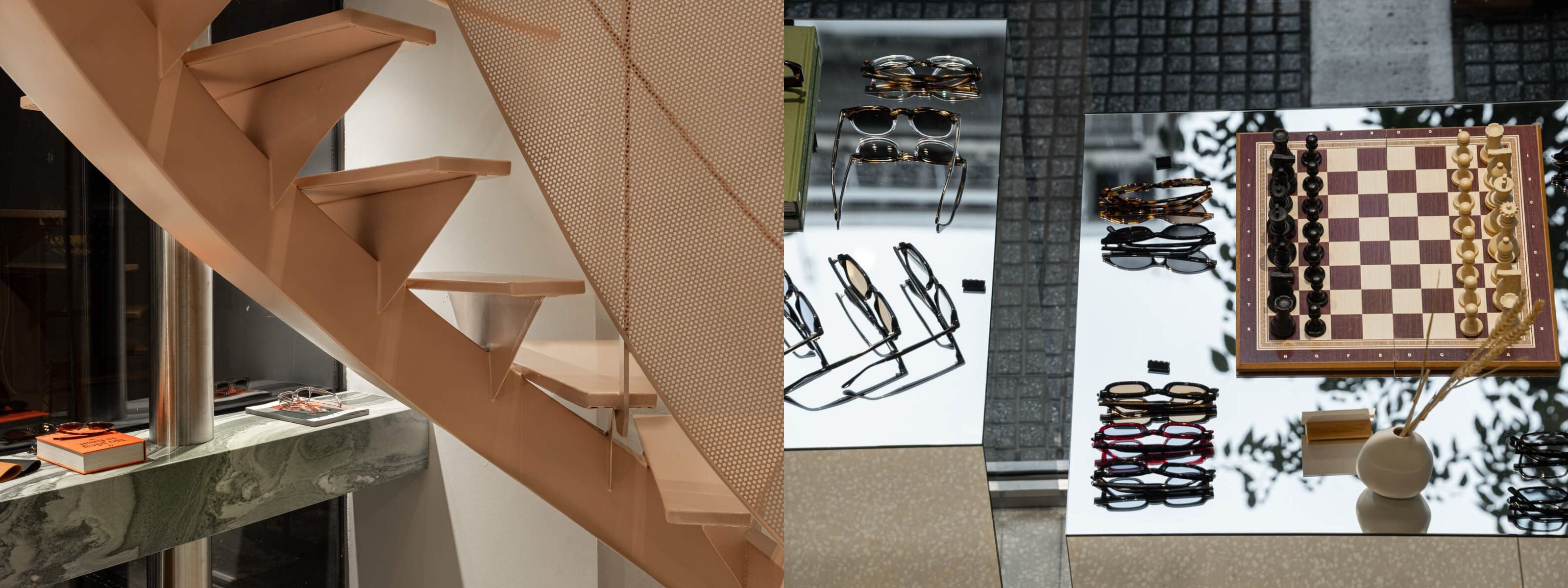 Interior staircase and mirrored display table with ME & JOE glasses and chessboard inside the Tsimiski store