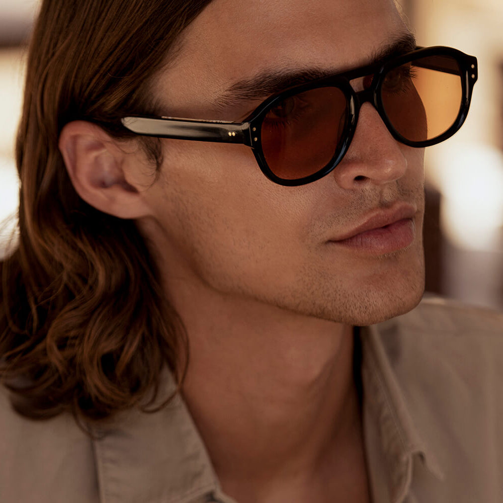 Man wearing sunglasses with a blurred background