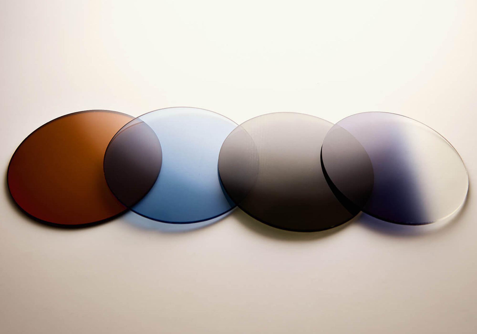 Premium ZEISS sun lenses in brown, blue, grey, and gradient shades for ME & JOE handcrafted eyewear