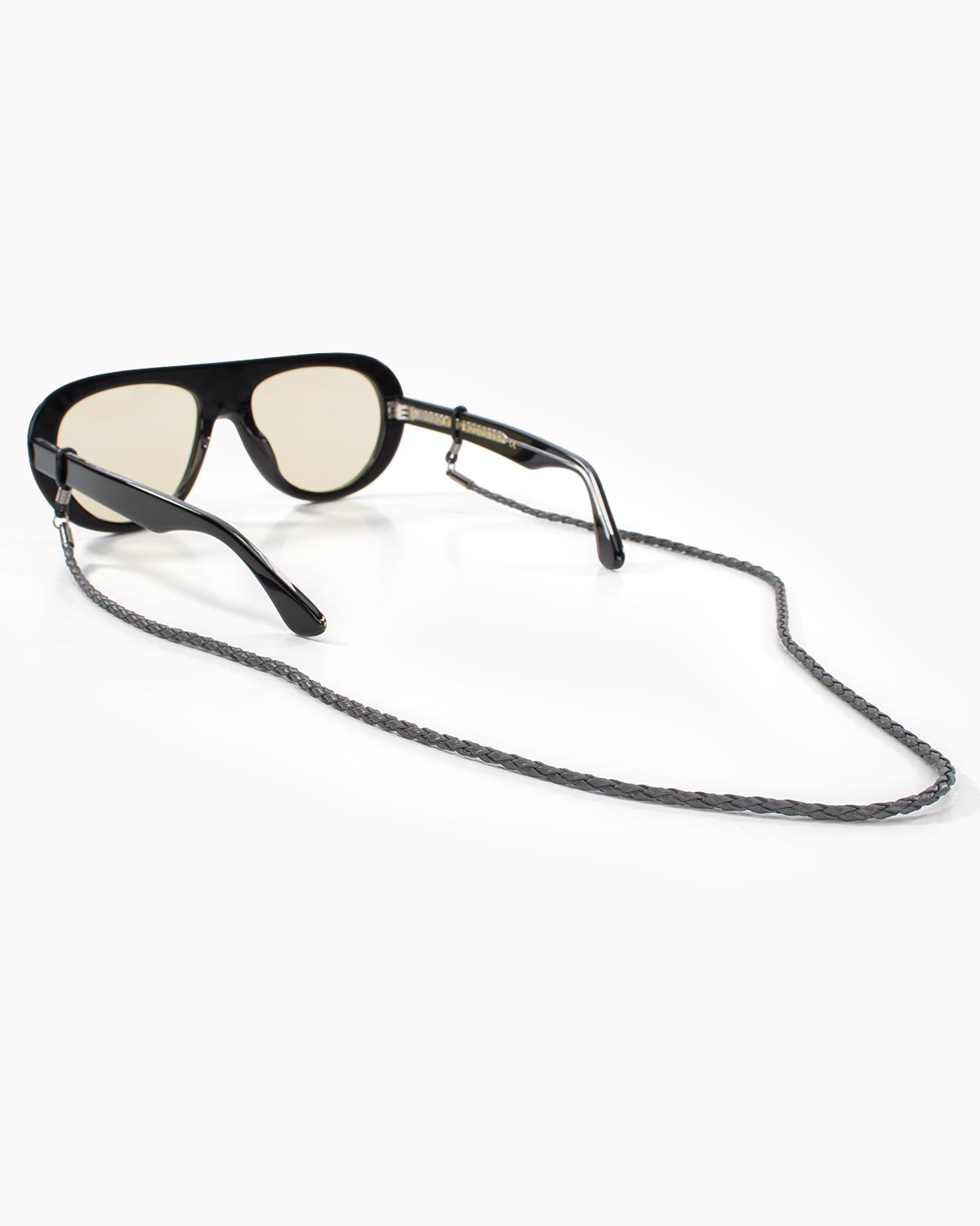 Rear view of grey braided eyewear chain attached to black sunglasses