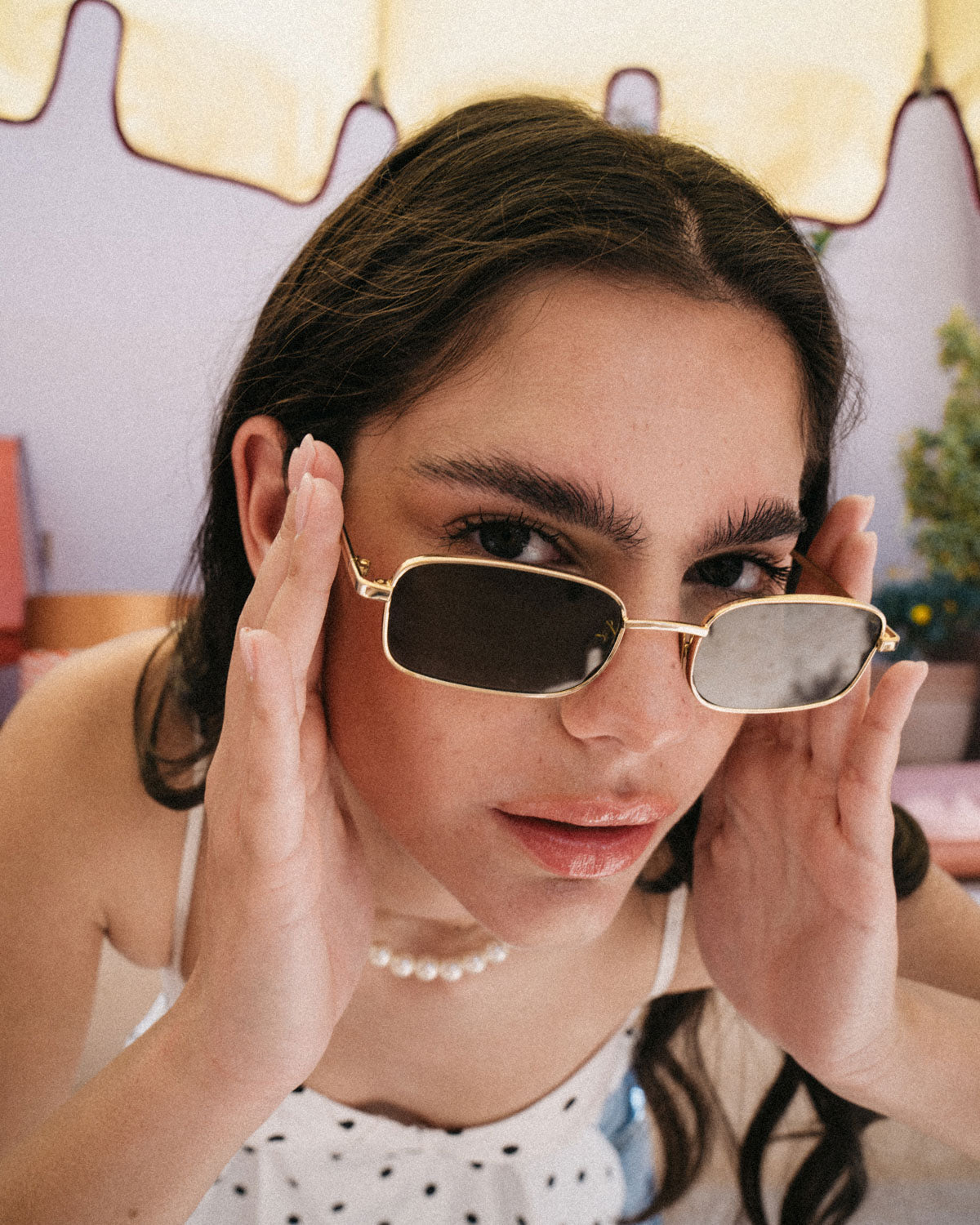 Woman wearing ME & JOE Luka gold sunglasses – lifestyle view