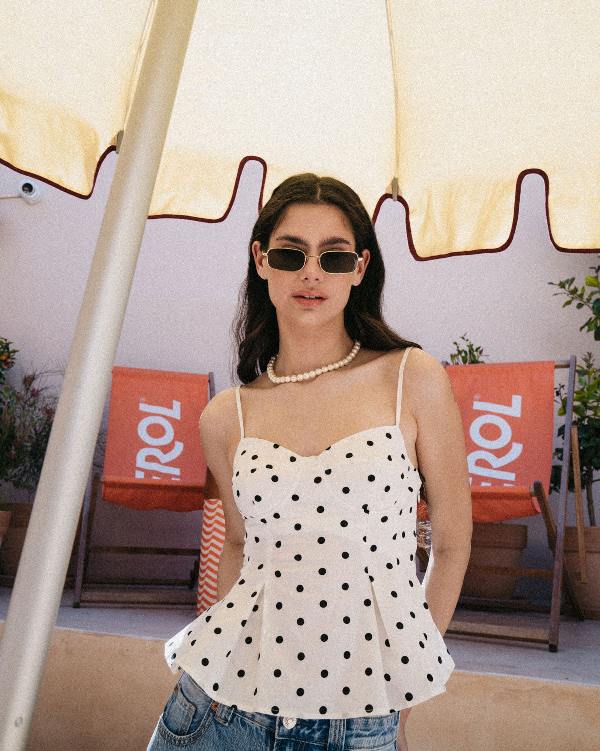 Woman wearing ME & JOE Luka gold sunglasses – lifestyle view1