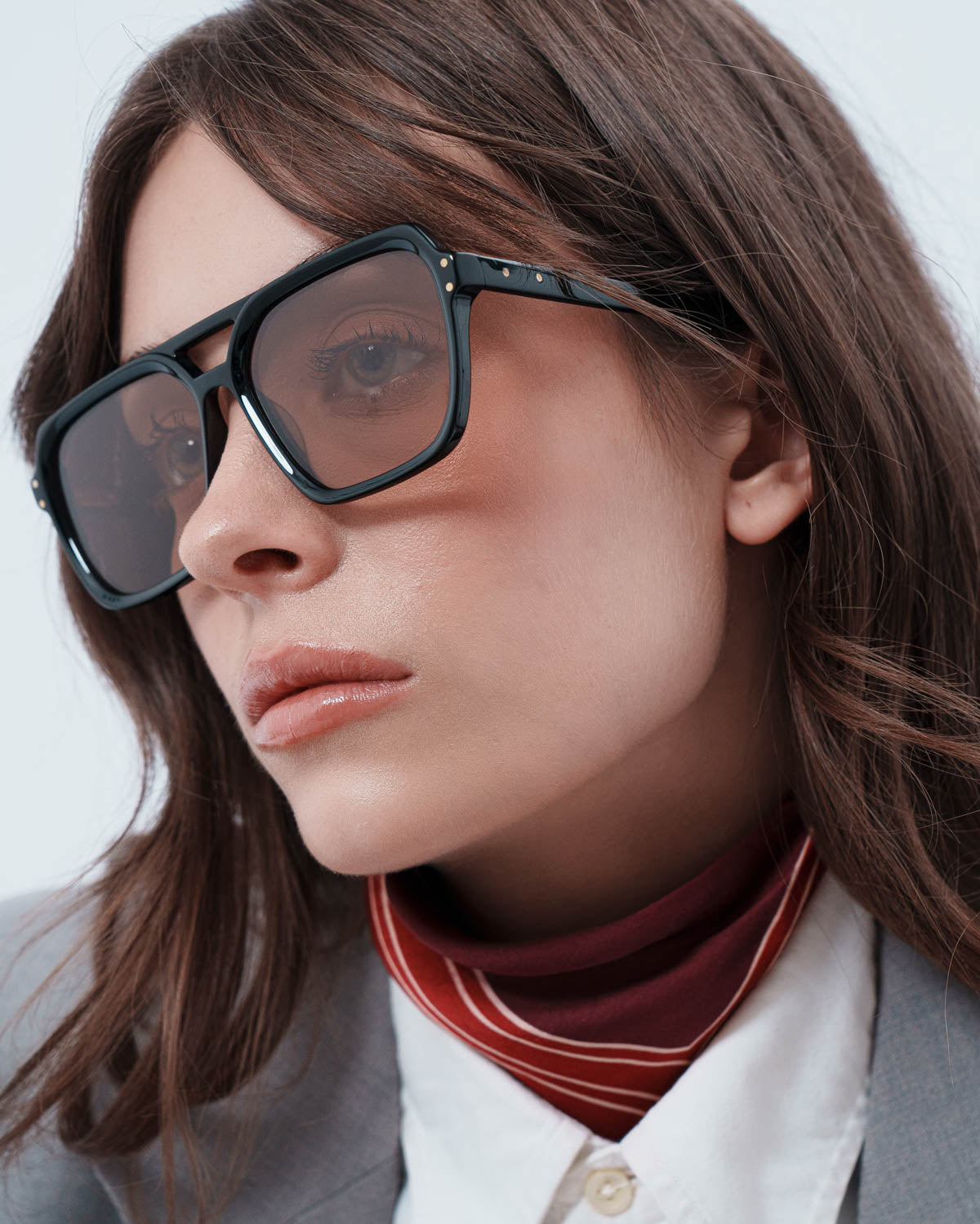 Woman wearing ME & JOE Madison black sunglasses – three-quarter view