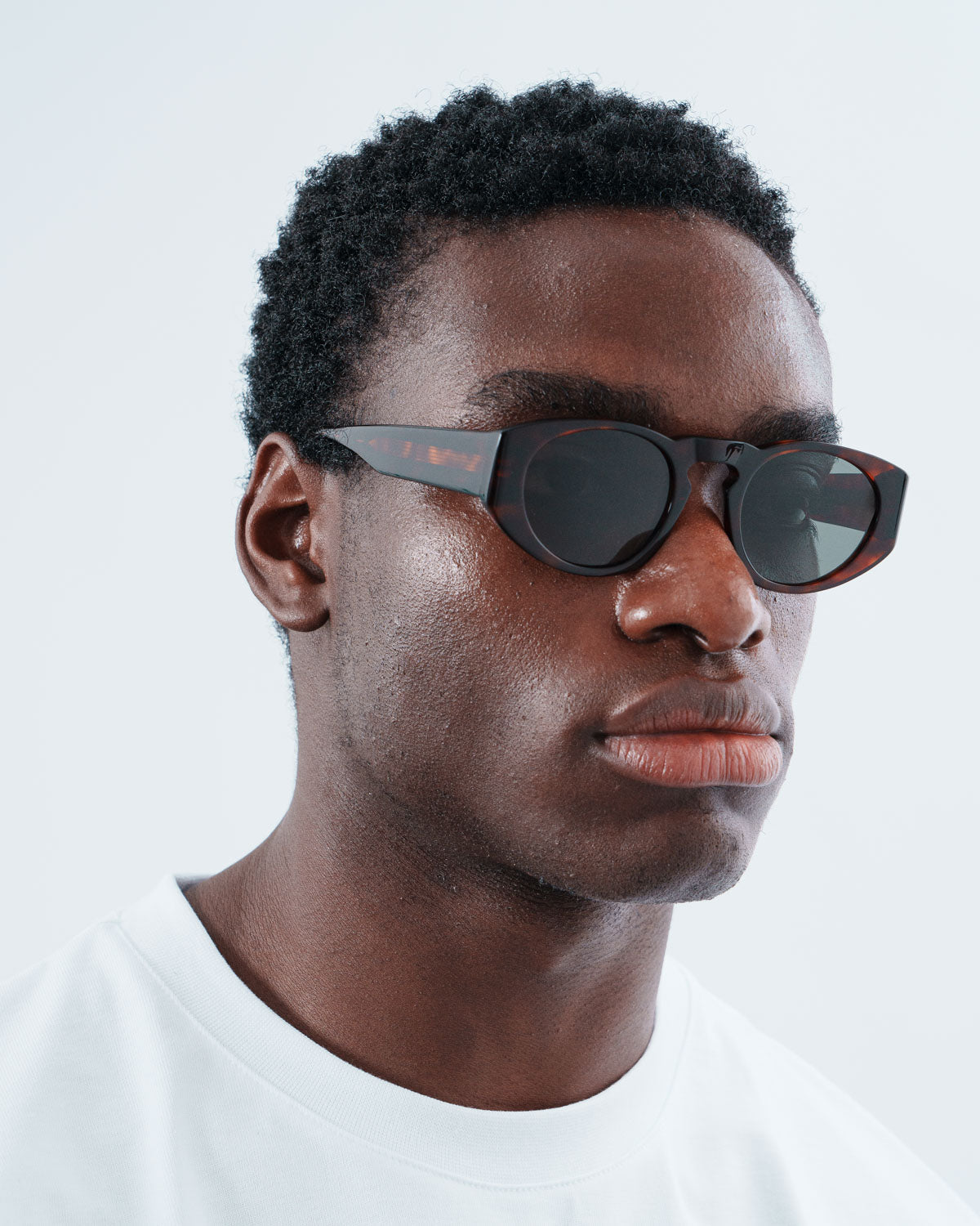 Man wearing ME & JOE Onassis tortoise sunglasses – three-quarter view