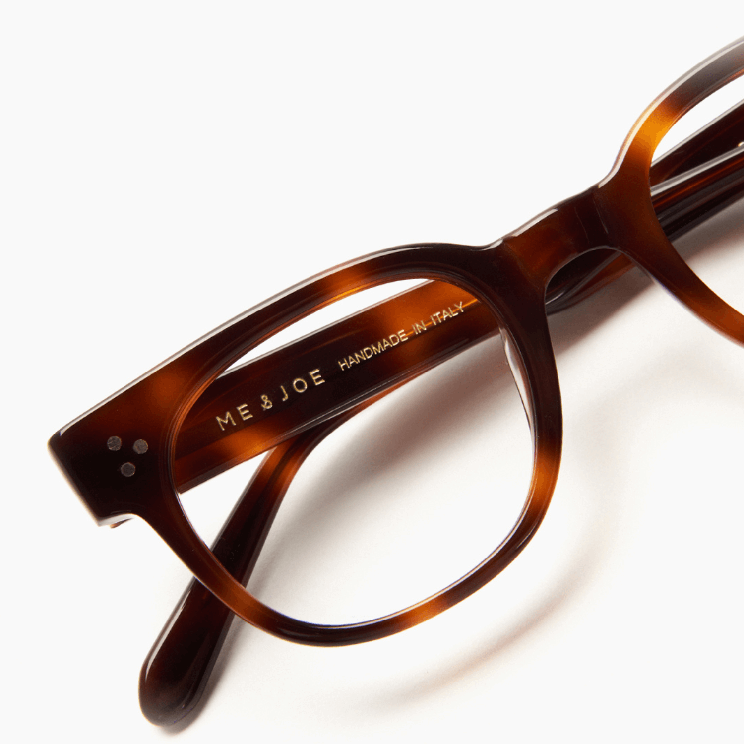 Tortoiseshell eyeglasses with 'ME & JOE' branding on a white background